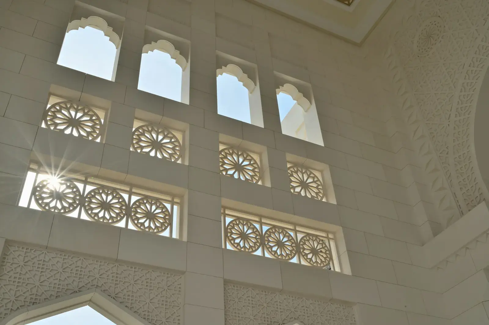 Ornate carved windows and arches inside a grand government building in Abu Dhabi